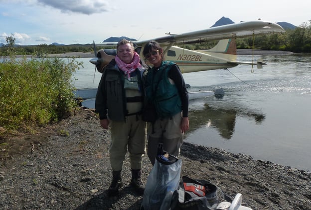 Two customers on the banks in Alaska fly fishing for salmon