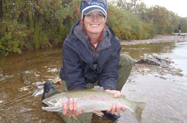lady customer with a cracking rainbow trout fly fishing alaska