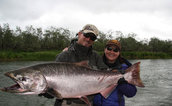 stunning picture of guide and customer with a big fresh king salmon from alaska