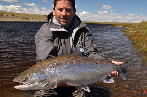 head guide holding a cracking sea trout in argentina with sportquest holidays