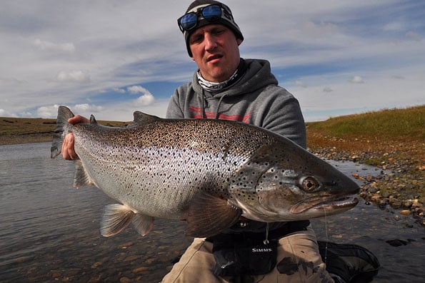 guide holding up a beast of a sea trout in argentina Las Buitreras Season Report
