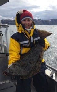Lady angler holding her halibut for this Fishing report Norway