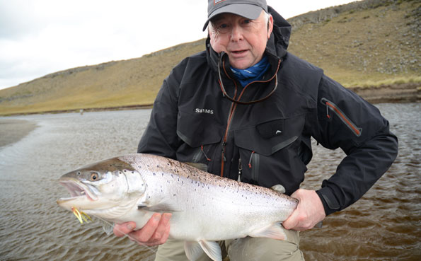 holding up a big fat sea trout from argentina