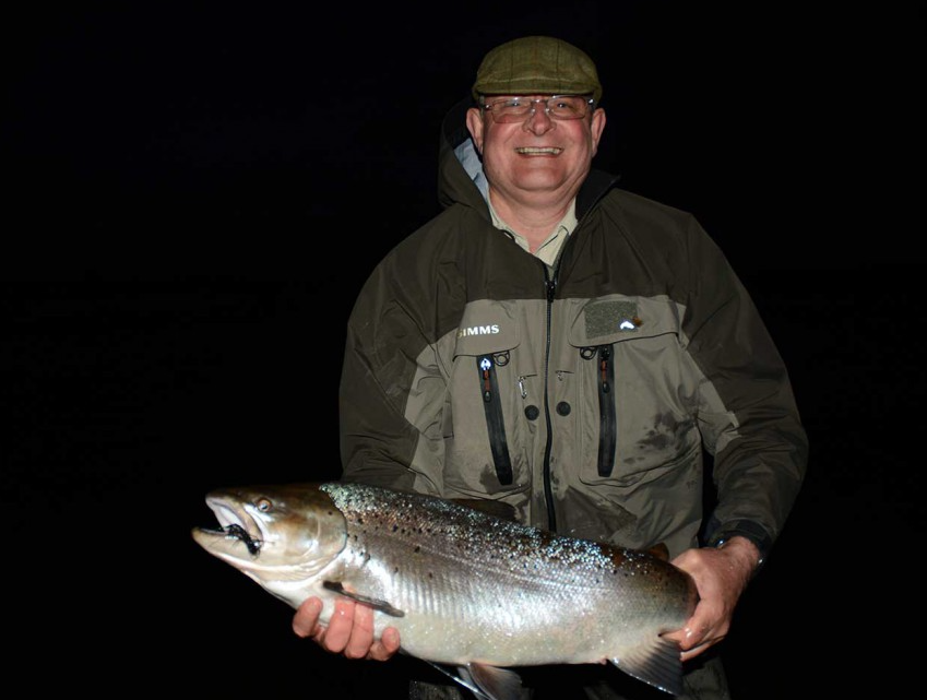 Customer holding a sea trout at night Sea Trout Rio Gallegos