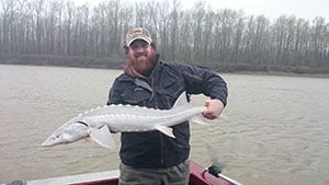 New Guide Clayton holding a sturgeon Fishing Report Canada