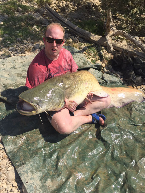 holding up his huge Catfish in Spain Fishing Report