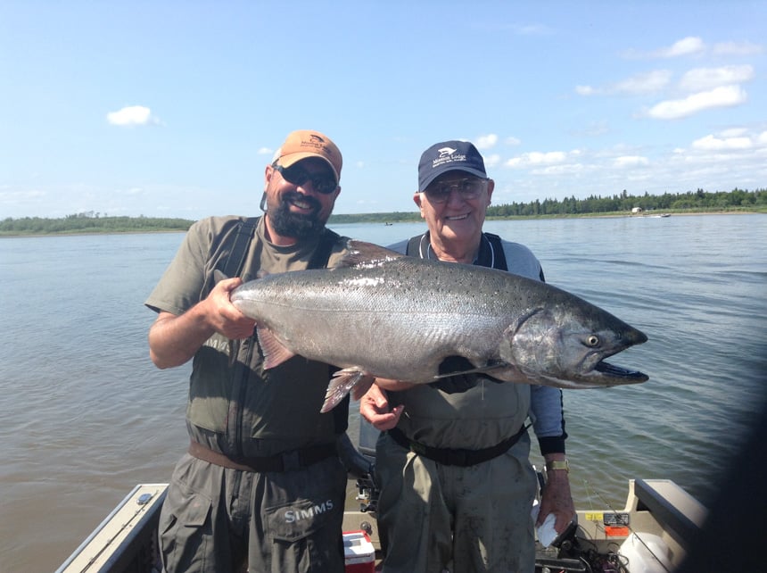 customer and guide holding up a very nice King Salmon caught fly fishing in alaska