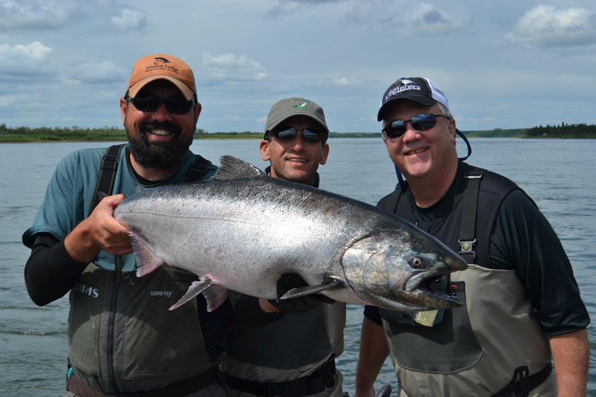 customer & guide holding a big king salmon caught fly fishing in alaska