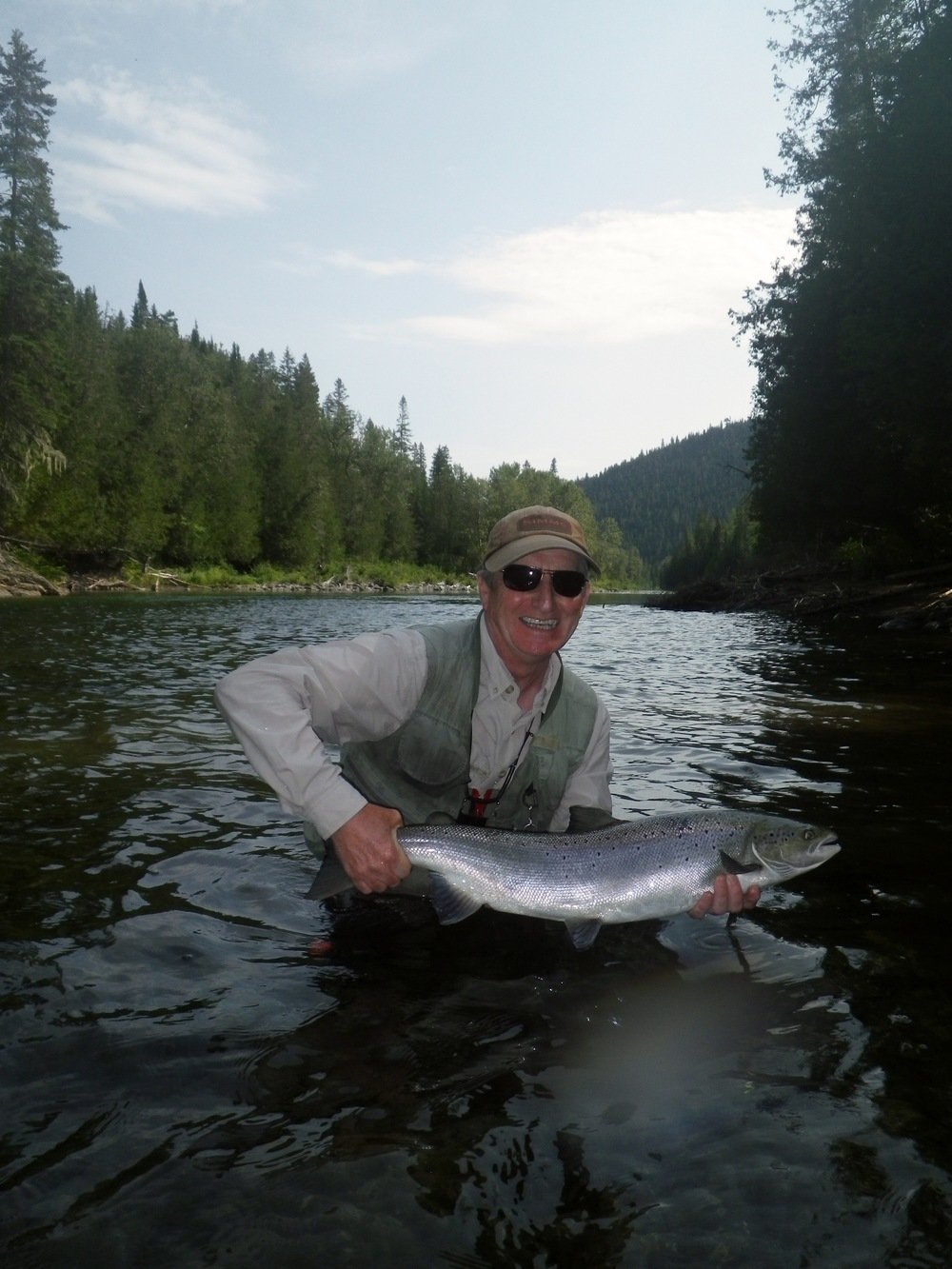 fly caught atlantic Salmon being returned to the water, we love catch and release.