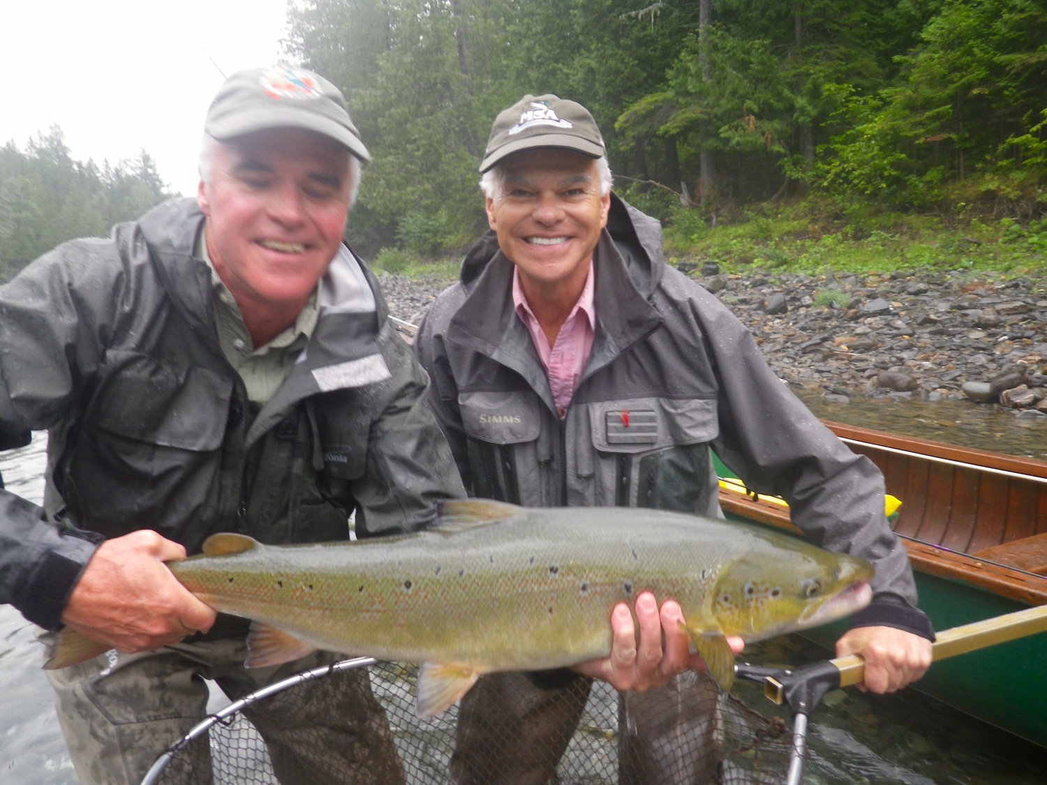 Two beaming smiles while returning another great Atlantic Salmon fish