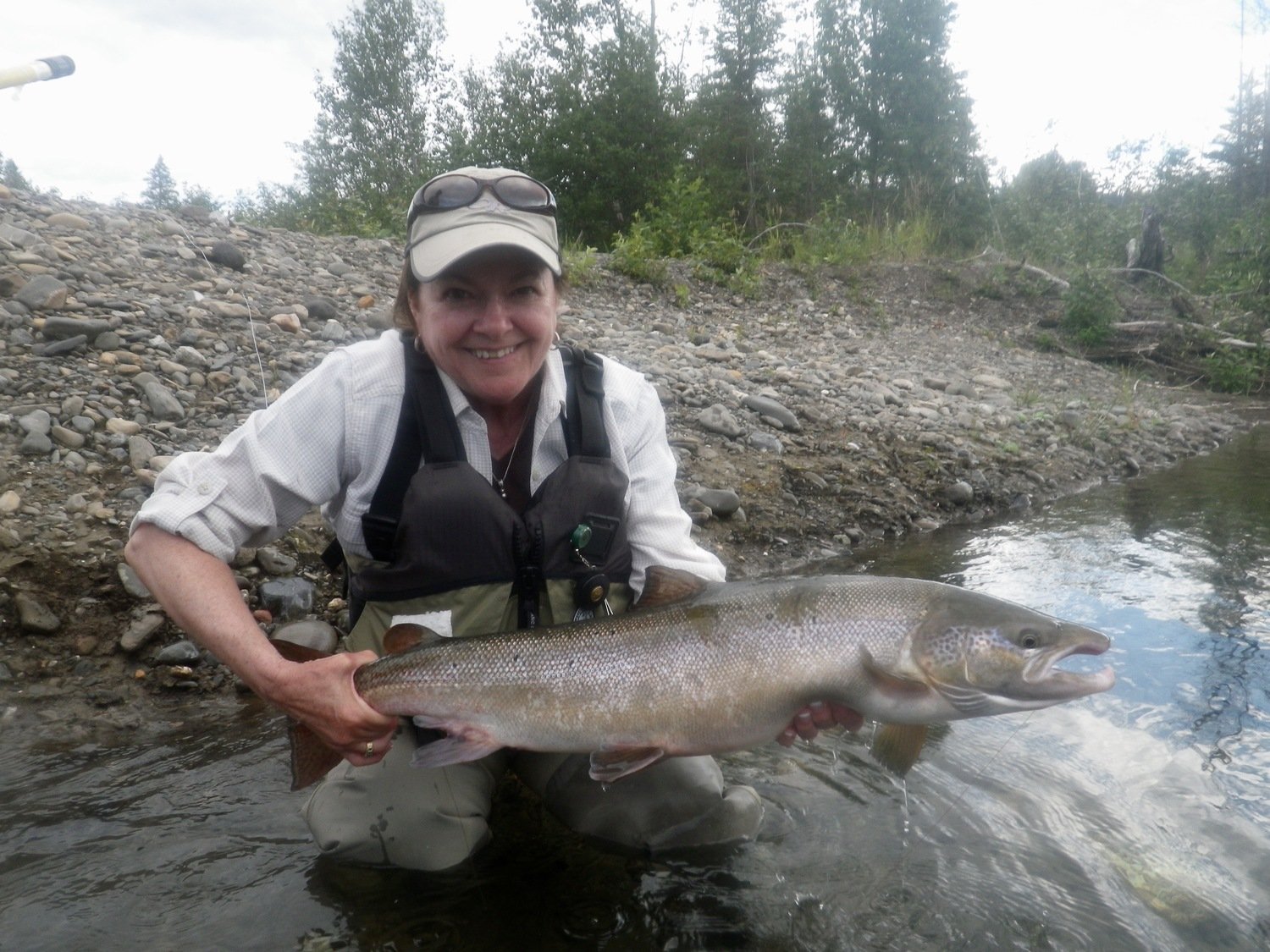 Lady angler with big Atlantic Salmon Canada Salmon Lodge Fishing River Report 