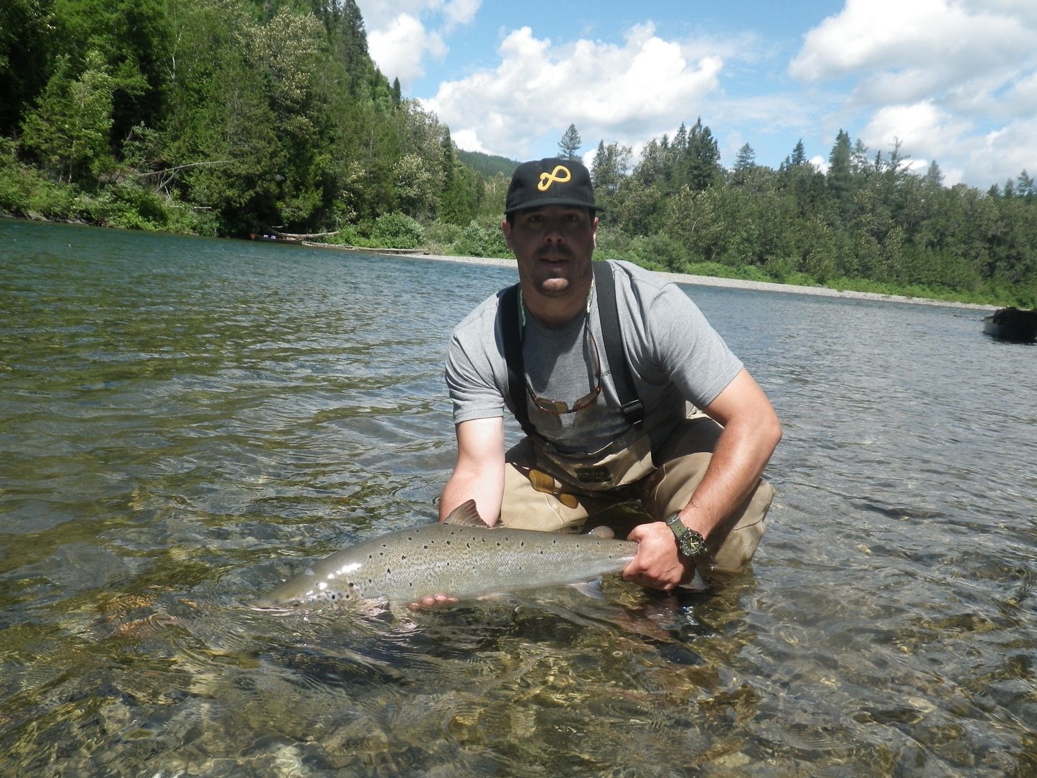 Customer with a nice Atlantic Salmon release Canada Salmon Lodge River Report