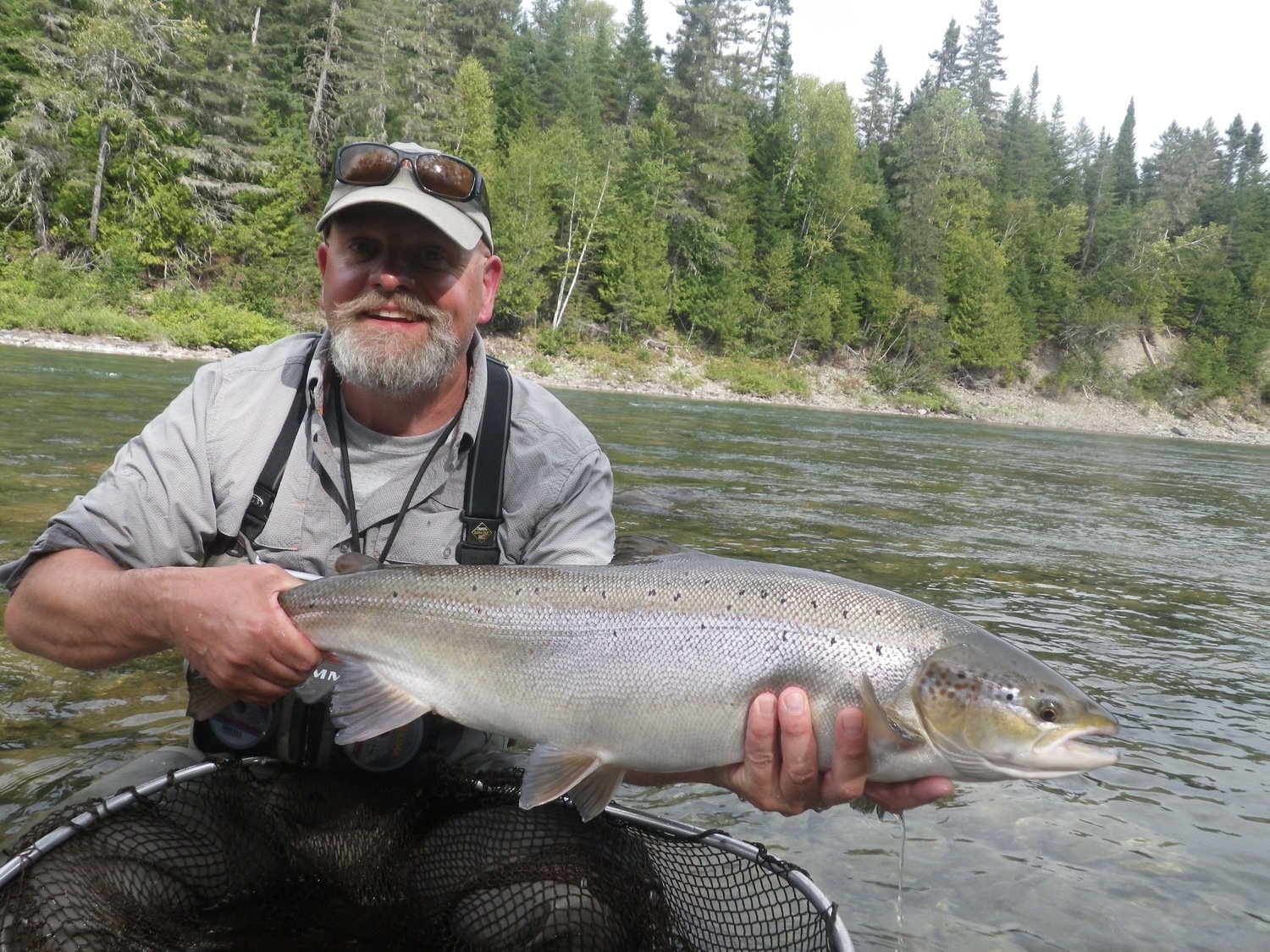 A happy angler with a fresh Atlantic Salmon from Camp Bonaventure Fishing Report