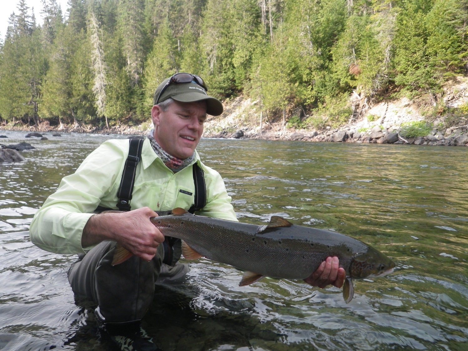 A classic pose with a fresh Atlantic Salmon caught fly fishing at our Camp Bonaventure
