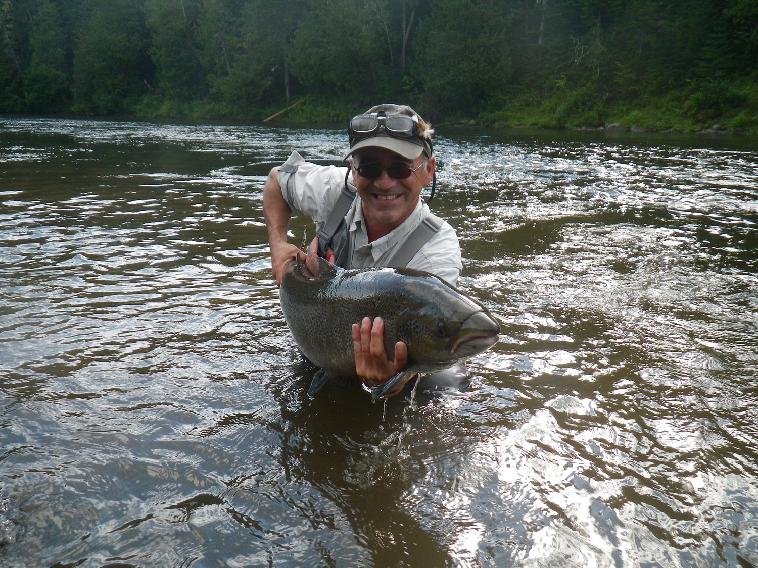 Salmon Lodge and Camp Bonaventure Guide Carol Barrault releases a huge one back to the Grand, this one is as big as he is!