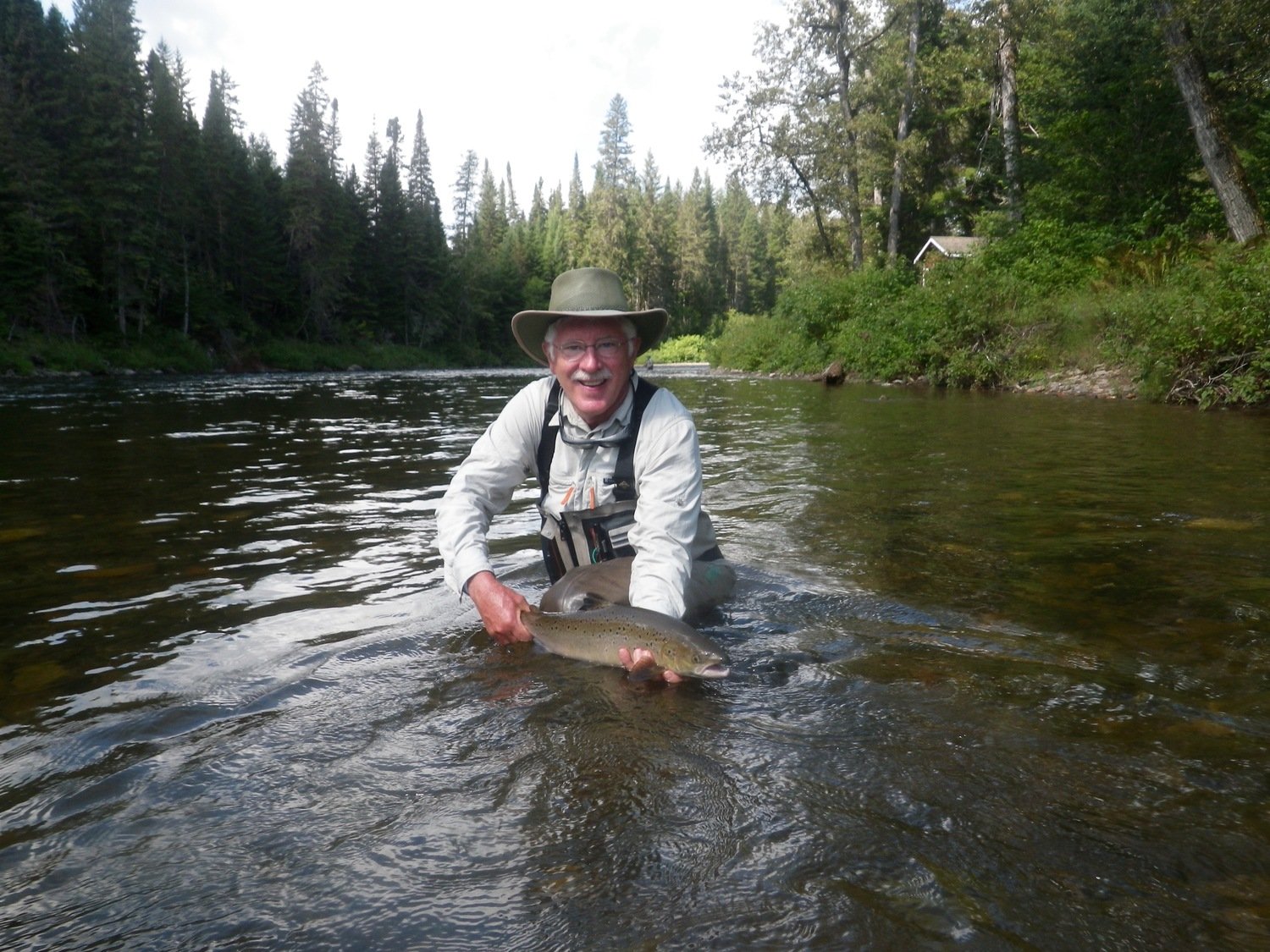 A very happy customer holding his Atlantic Salmon prize