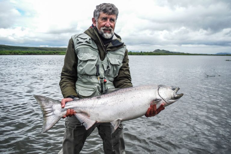 Another customers holding a big fresh Chinook salmon