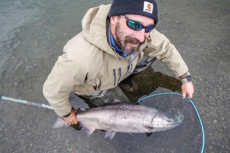 customer looking at camera as salmon rest in the water