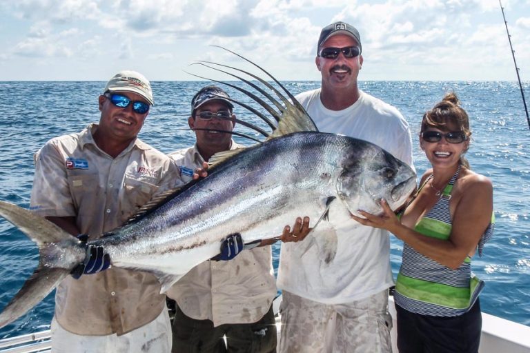 group of anglers with rooster fish