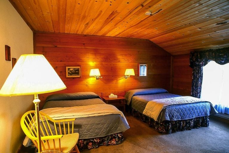 A wooden cabin bedroom