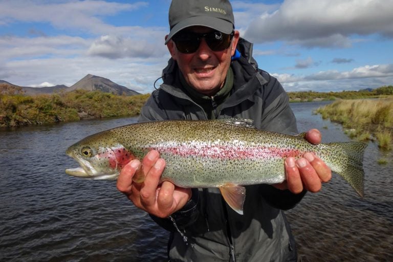 a small rainbow trout caught on a mouse pattern fly