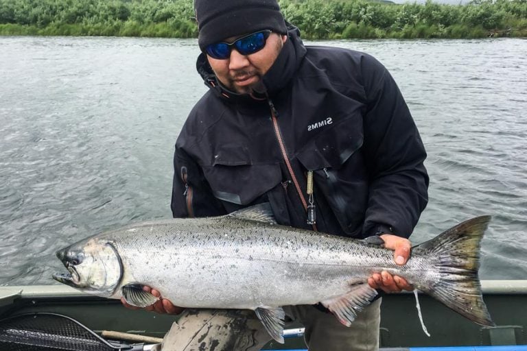 customer in boat holding a nice fresh caught salmon