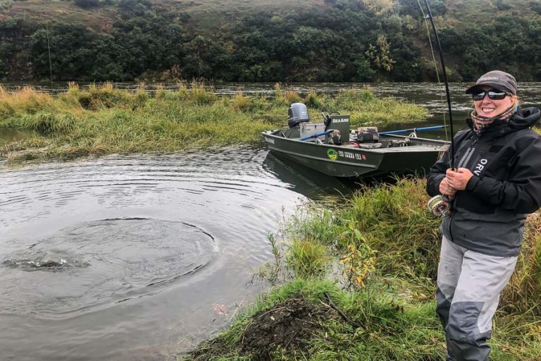 Tracey laughing as hse is playing another salmon from the goodnews river alaska