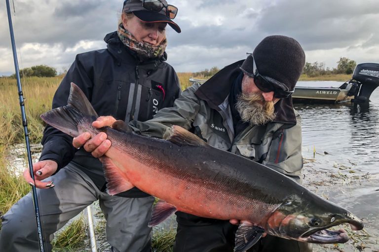 Tracey buckenham and guide chad holding a nice buck coho salmon