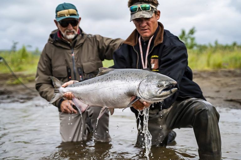 Customer and guide looking at a big King salmon