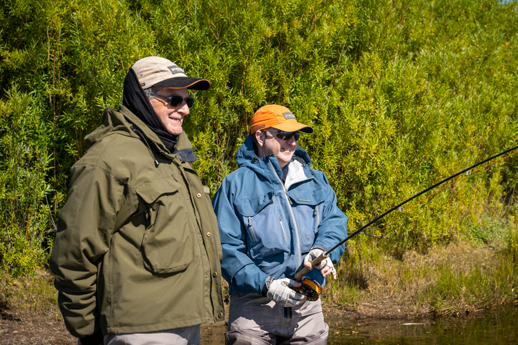 Two anglers observing the water