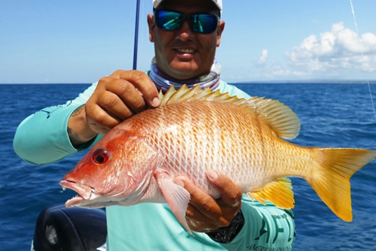 Fisherman with orange fish