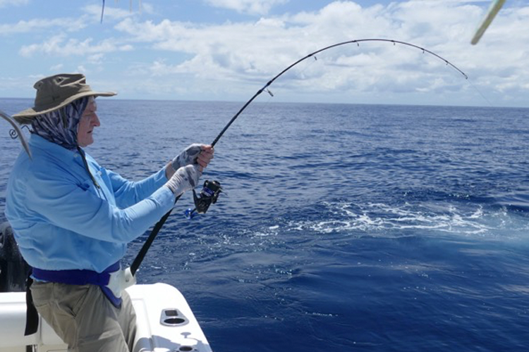 Angler playing a yellowfin tuna