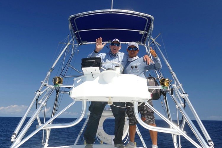 Two anglers at top of the boat