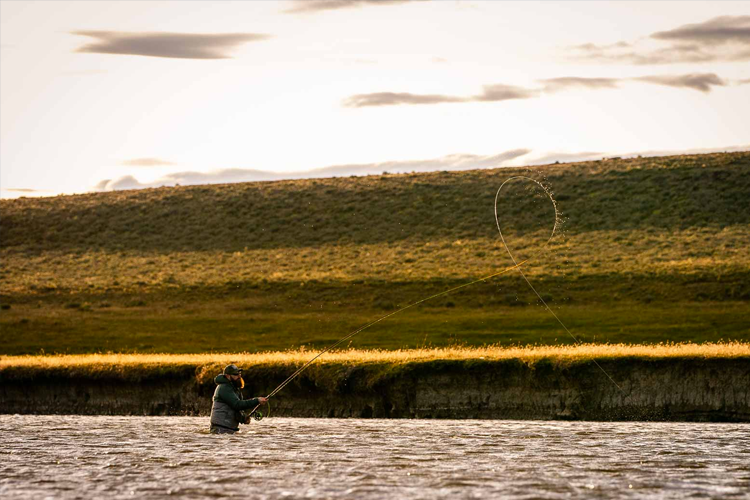 Angler casting while wading