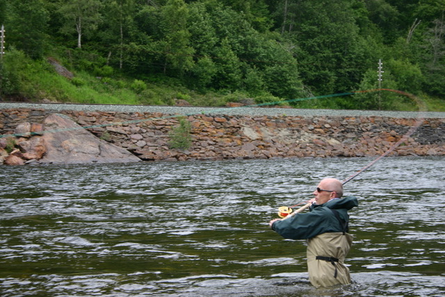 casting while wading for salmon