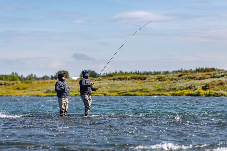 Guide and customer standing in the west ranga river iceland