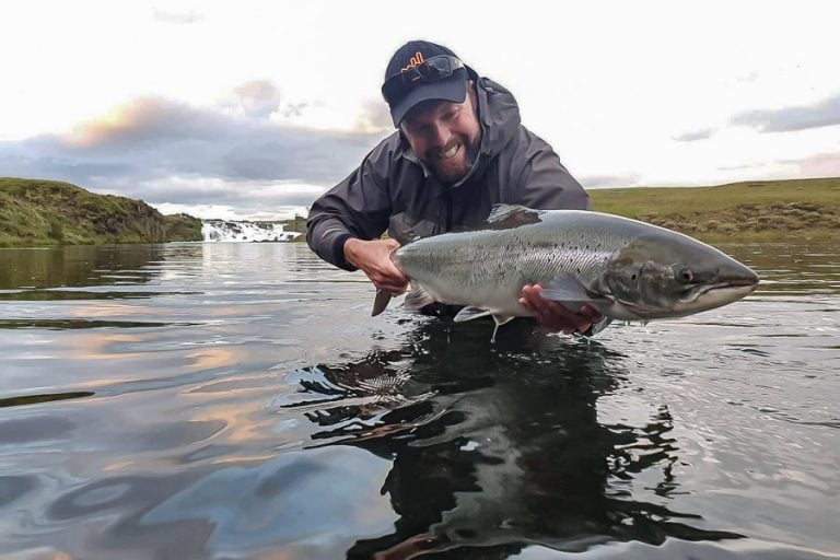 On a calm day customer looking very happy with his prize a big Atalntic Salmon from west ranga lodge in iceland