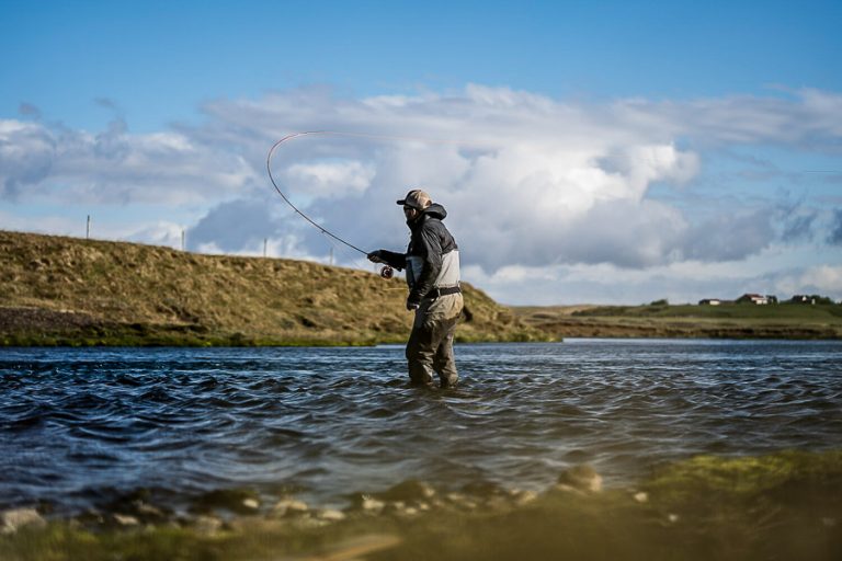 customer standing in the west ranga river swinging flies for atlantic salmon in iceland