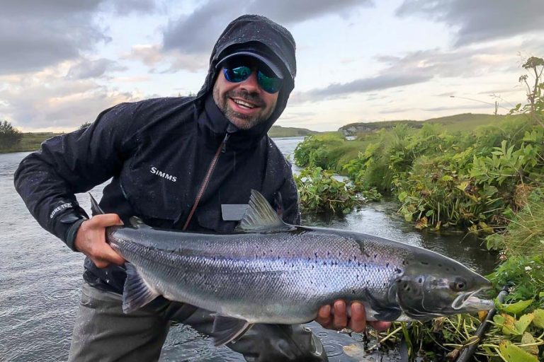 Customer with a huge smile looking very happy holding his Atlantic Salmon from the west ranga river