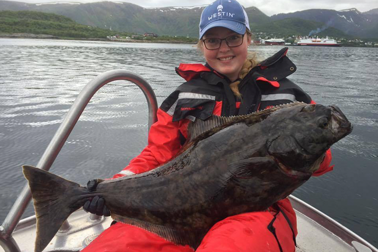 angler with halibut before return